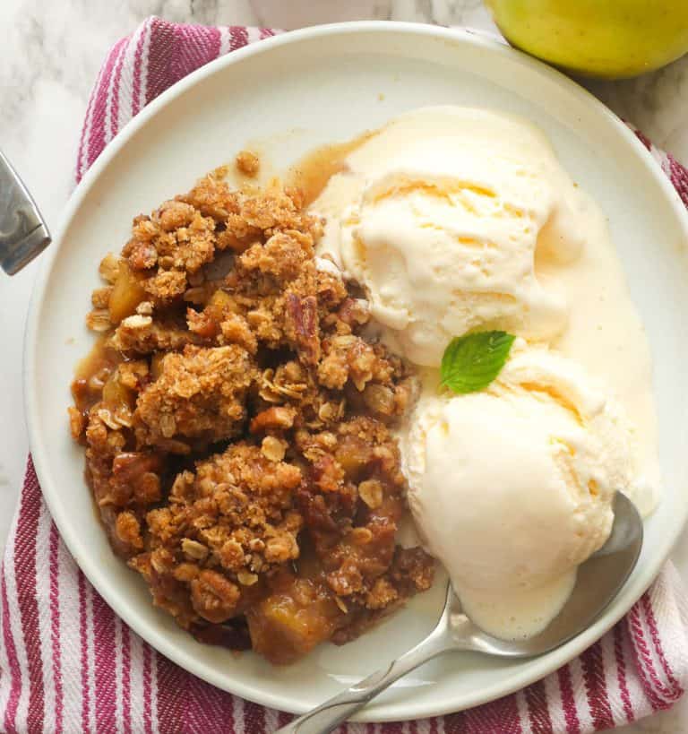 Enjoying a slice of apple crisp with vanilla ice cream.
