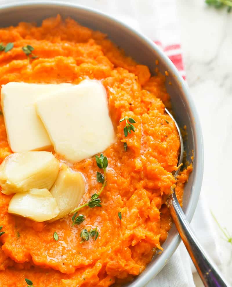 A Bowl of Mashed Sweet Potatoes with Spoon