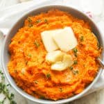Mashed Sweet Potatoes Topped with Butter and Roasted Garlic