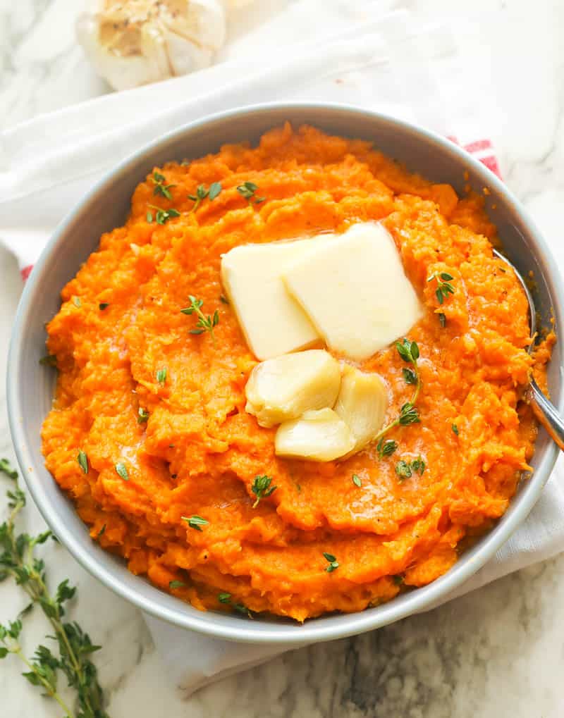 Mashed Sweet Potatoes Topped with Butter and Roasted Garlic