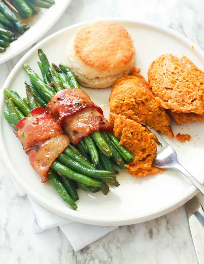 Bacon Wrapped Green Beans Served with Sweet Potato Souffle and a Biscuit