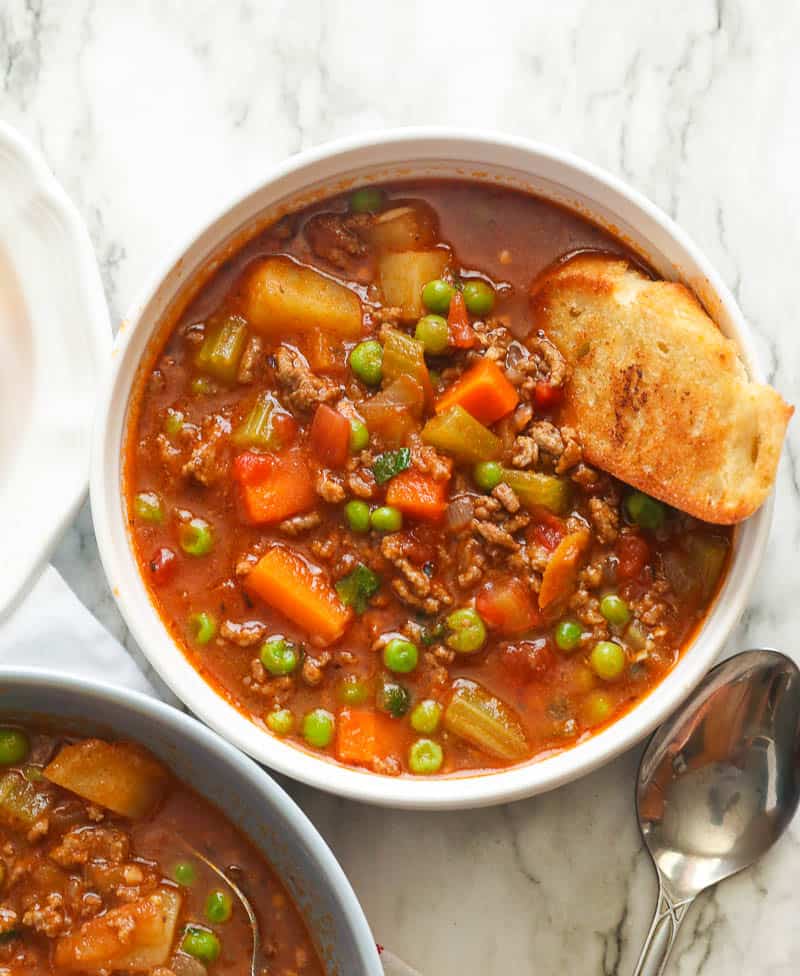 A Bowl of Hamburger Soup Served with Bread Toast