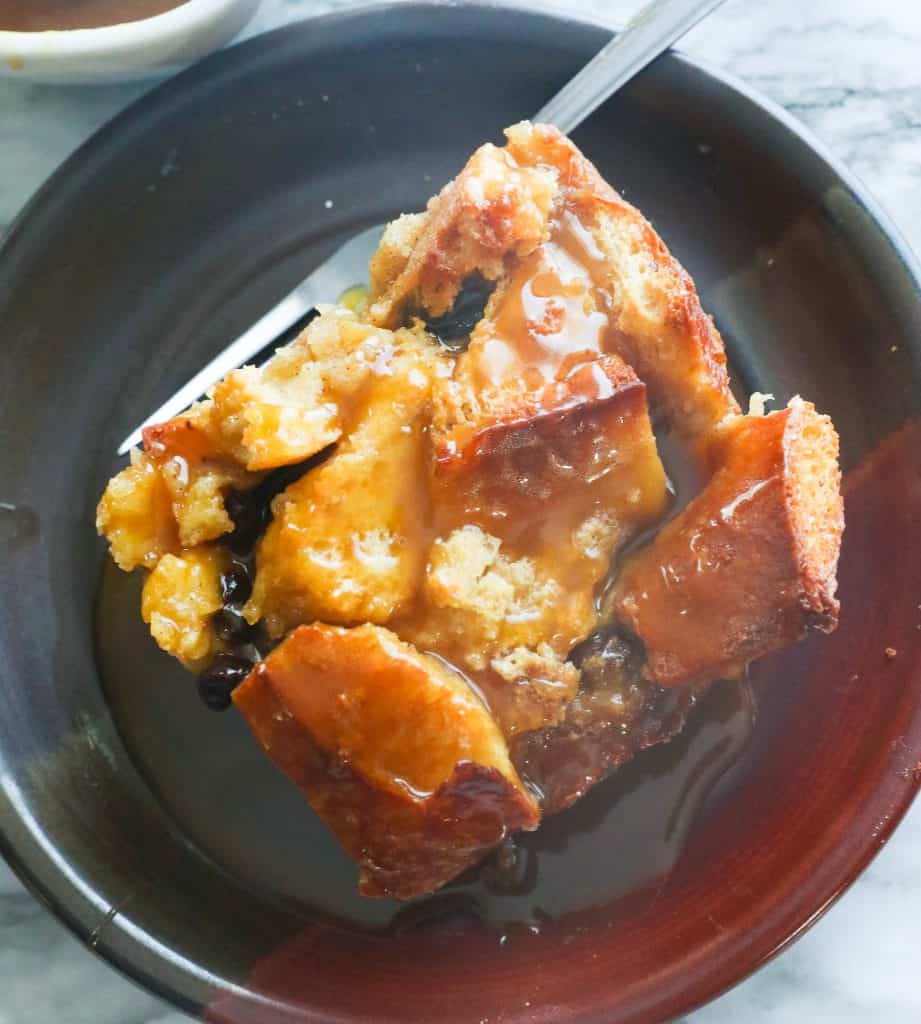 Slice of Bread Pudding with Rum Sauce on a Plate