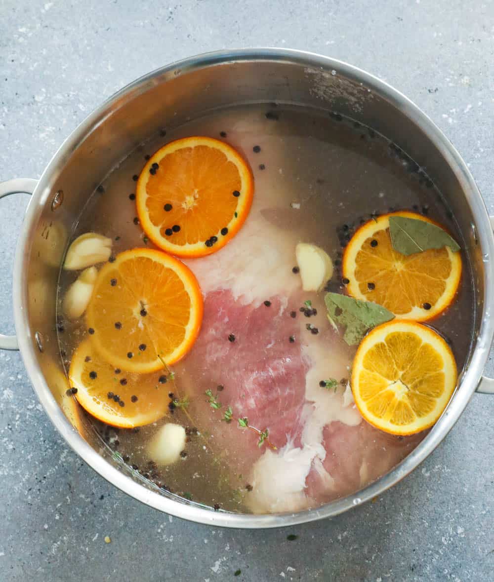 Pork Chop in Brine solution with herbs and orange slices