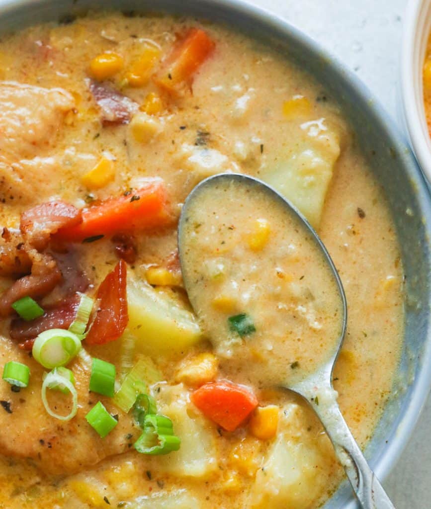 A Bowl of Chicken Corn Chowder with a Spoon