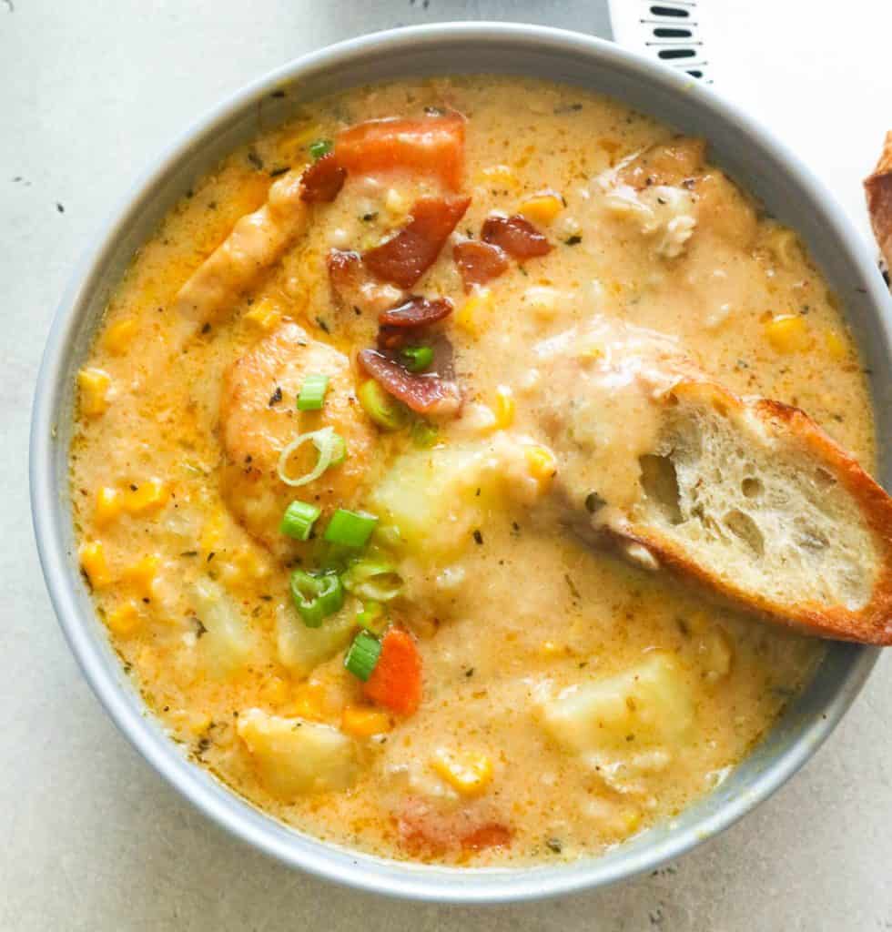 Crusty Bread Dipped on a Bowl of Chicken Corn Chowder