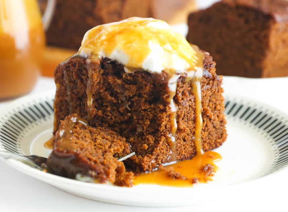 Decadent Slice of Gingerbread Cake Topped with Vanilla Ice Cream and Butterscotch Sauce