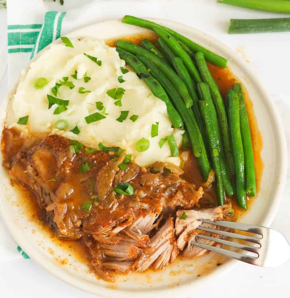 Fork-tender country style ribs served with mashed potatoes and green beans