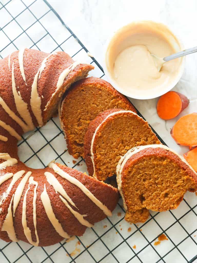 Slices of Sweet Potato Pound Cake with glaze on the side some sweet potato slices