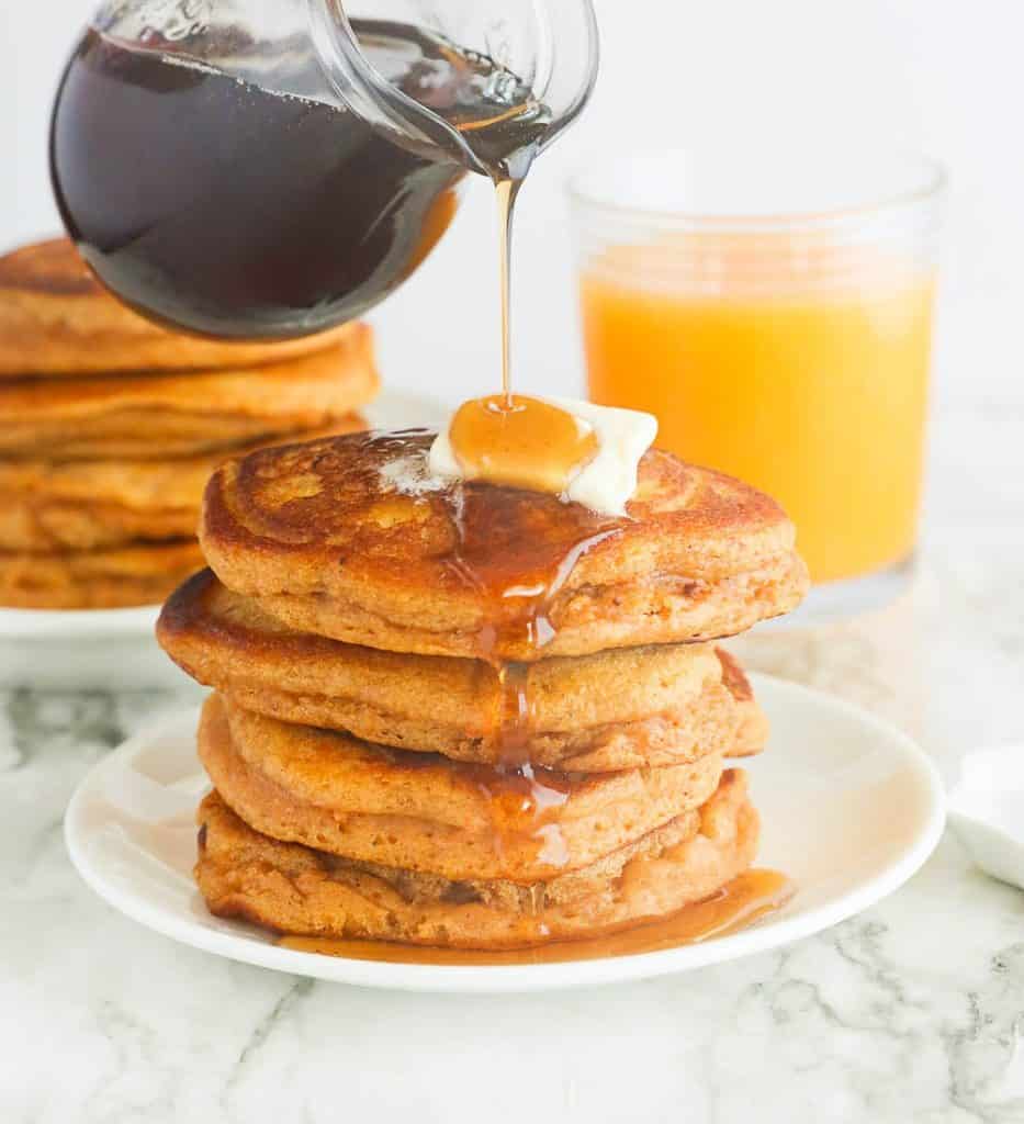 Stack of sweet potato pancakes with butter and syrup