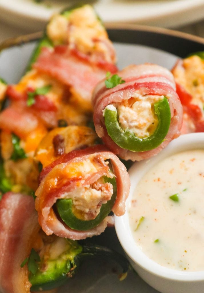 A bite off bacon wrapped jalapeno poppers served with a remoulade sauce