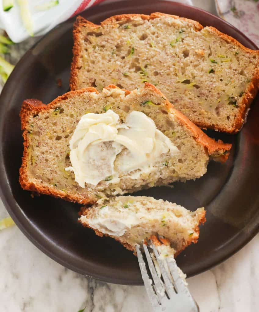 Slices of Banana Zucchini Bread Slathered with Butter