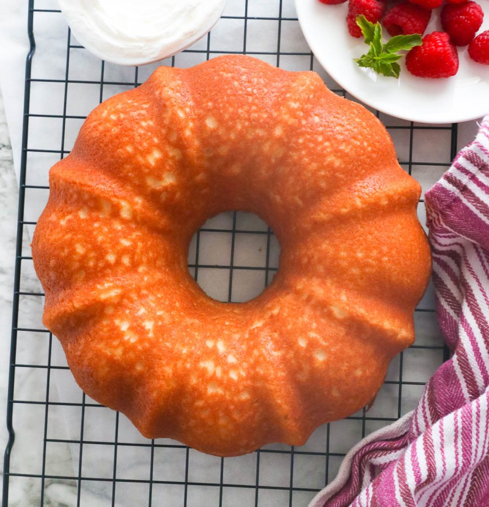 Freshly baked hot milk cake on a cooling rack