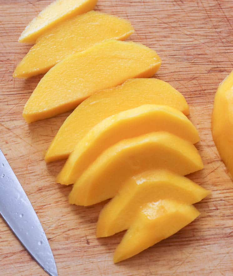 Freshly sliced mango on a chopping board