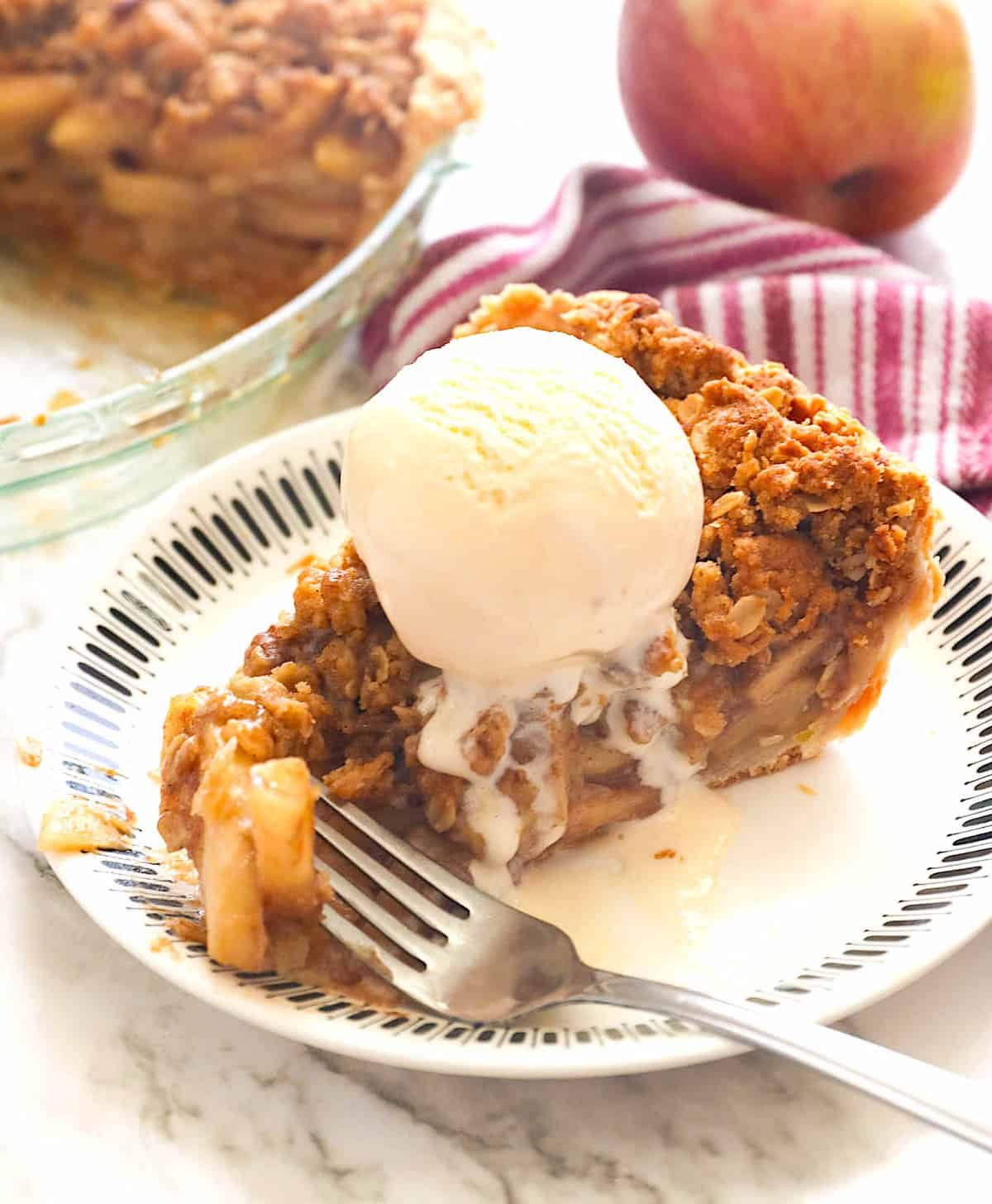 A slice of sweet dutch apple pie served with refreshing ice cream