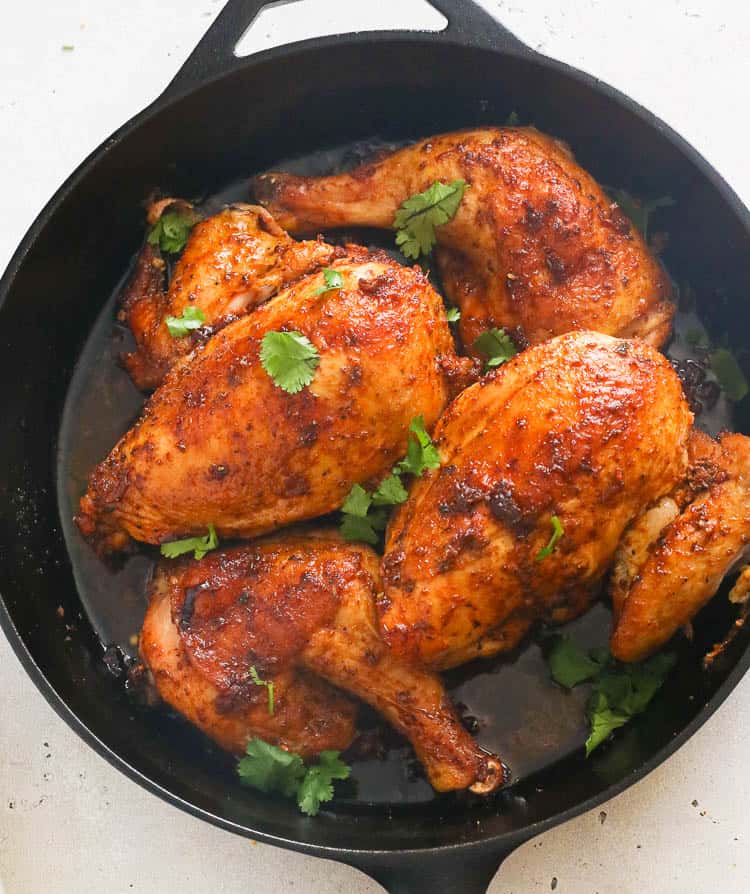 Cut-up Pieces of Peruvian Style Roast Chicken in a Cast Iron Pan