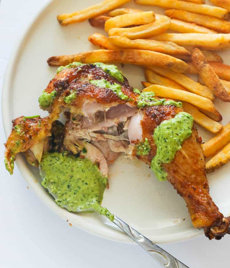 Peruvian Style Roast Chicken Leg Smothered with Green Sauce and Served with Fries