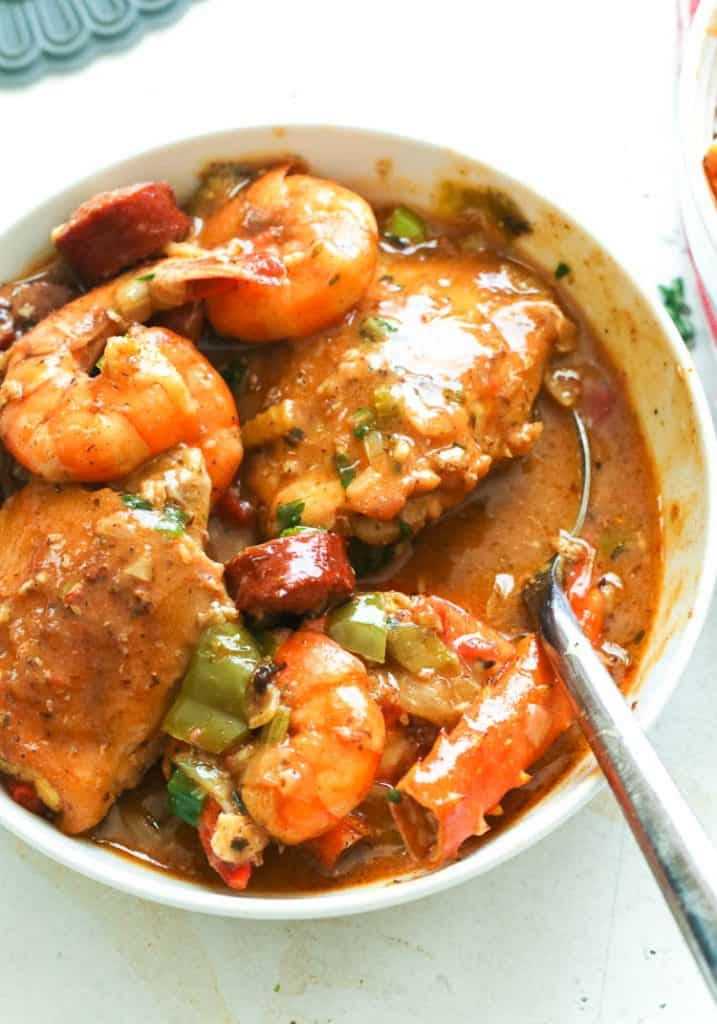a bowl of gumbo dish with a spoon to scoop it out