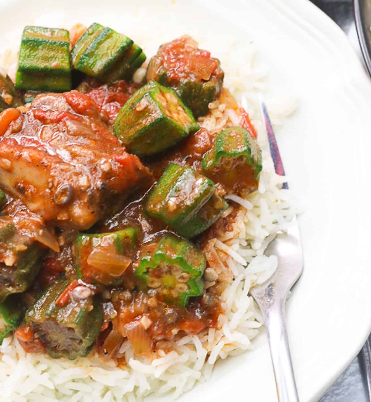 a plateful of white rice topped with okra stew