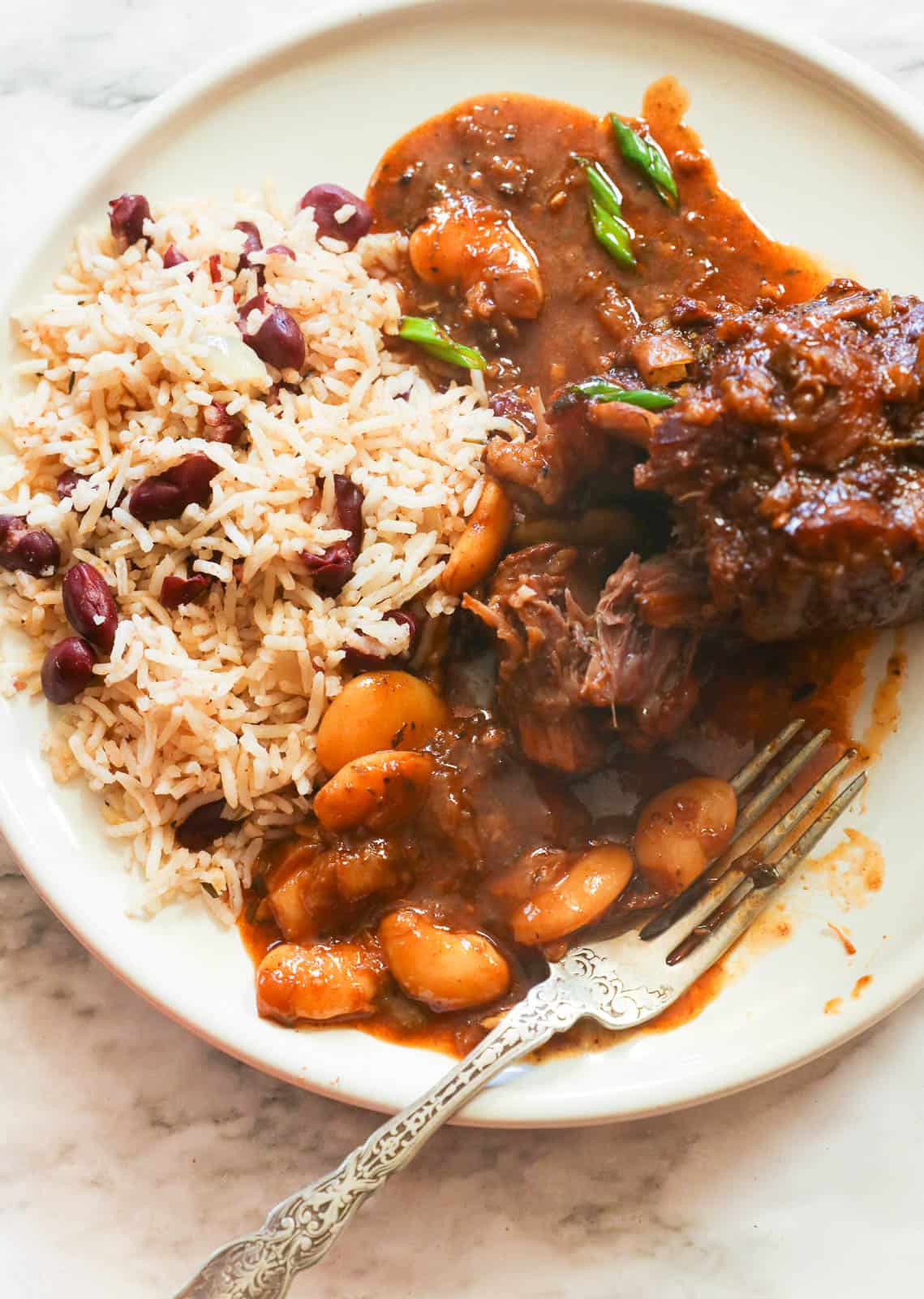 Jamaican oxtail stew served with Caribbean rice and beans