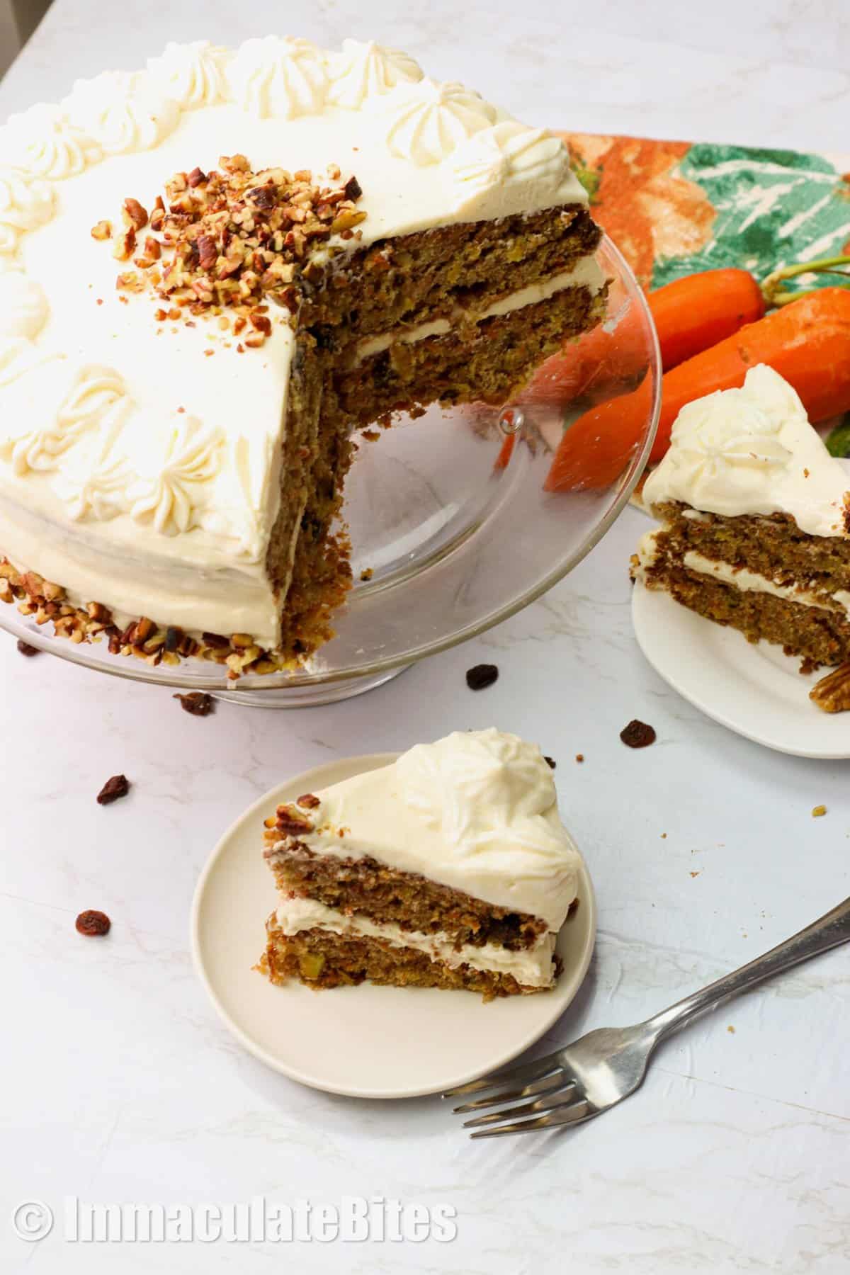 Pineapple Carrot Cake sliced with fresh carrots in the background