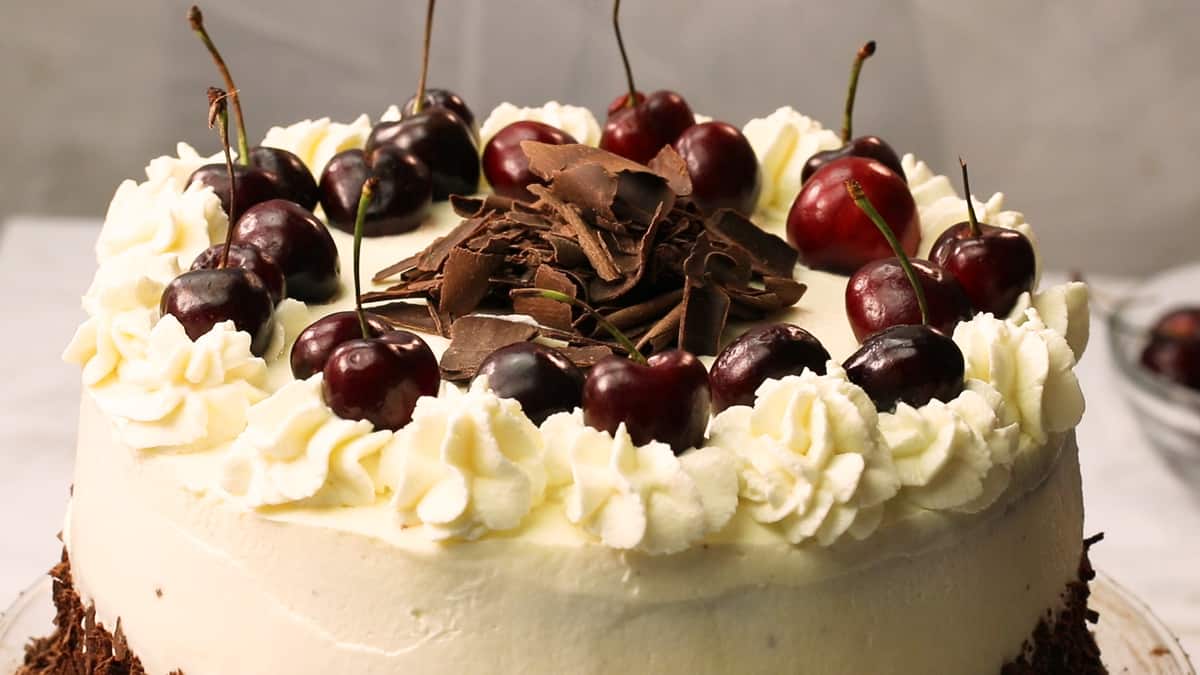 Top Half Shot of Black Forest Cake Topped with Cherries and Chocolate Shavings