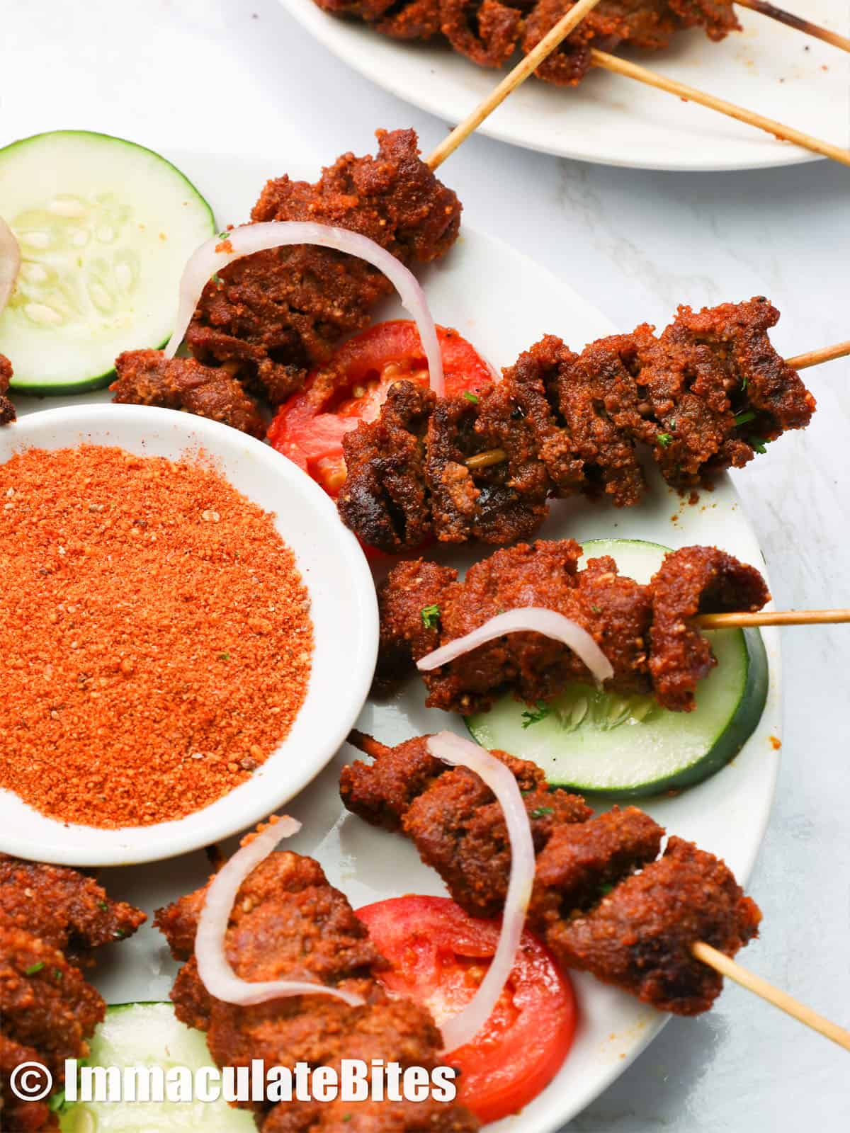 suya beef served with a bowl of spicy nutty rub