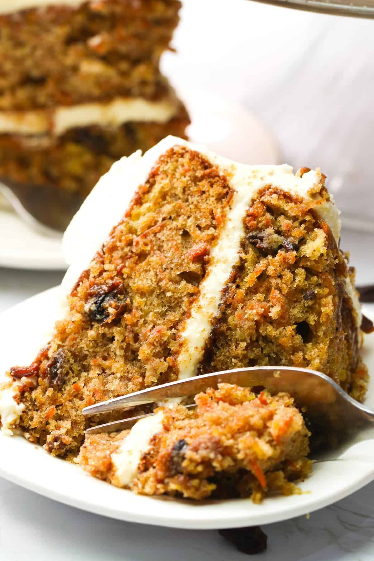 Forking into a decadent slice of carrot cake with crushed pineapple.