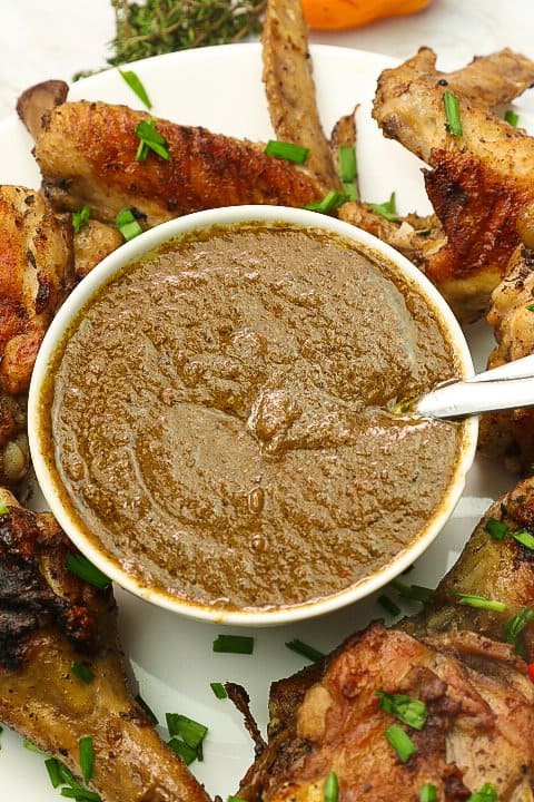 Jamaican jerk sauce with chicken wings on a white platter
