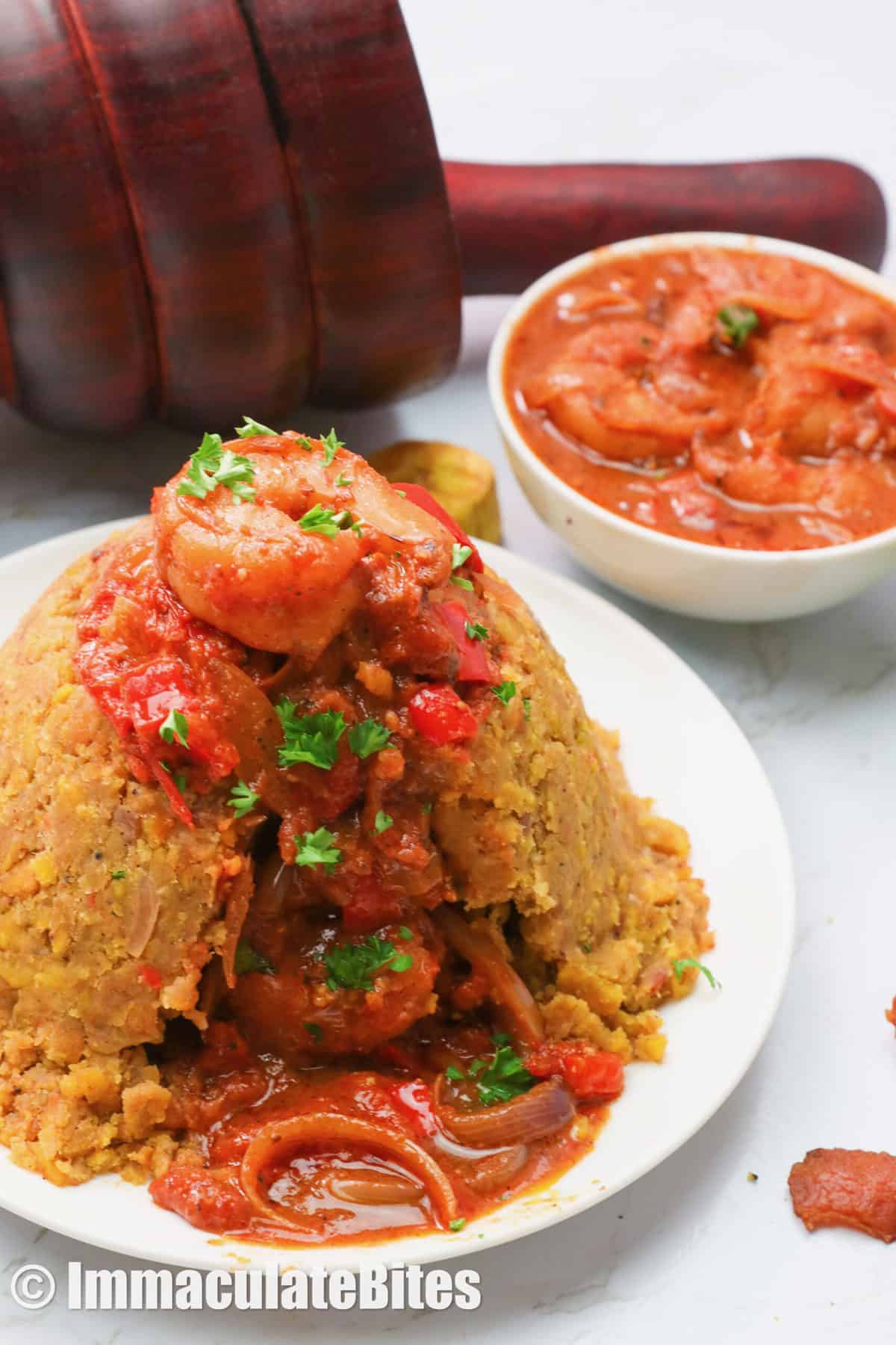 Mofongo with shrimp sauce on a white plate