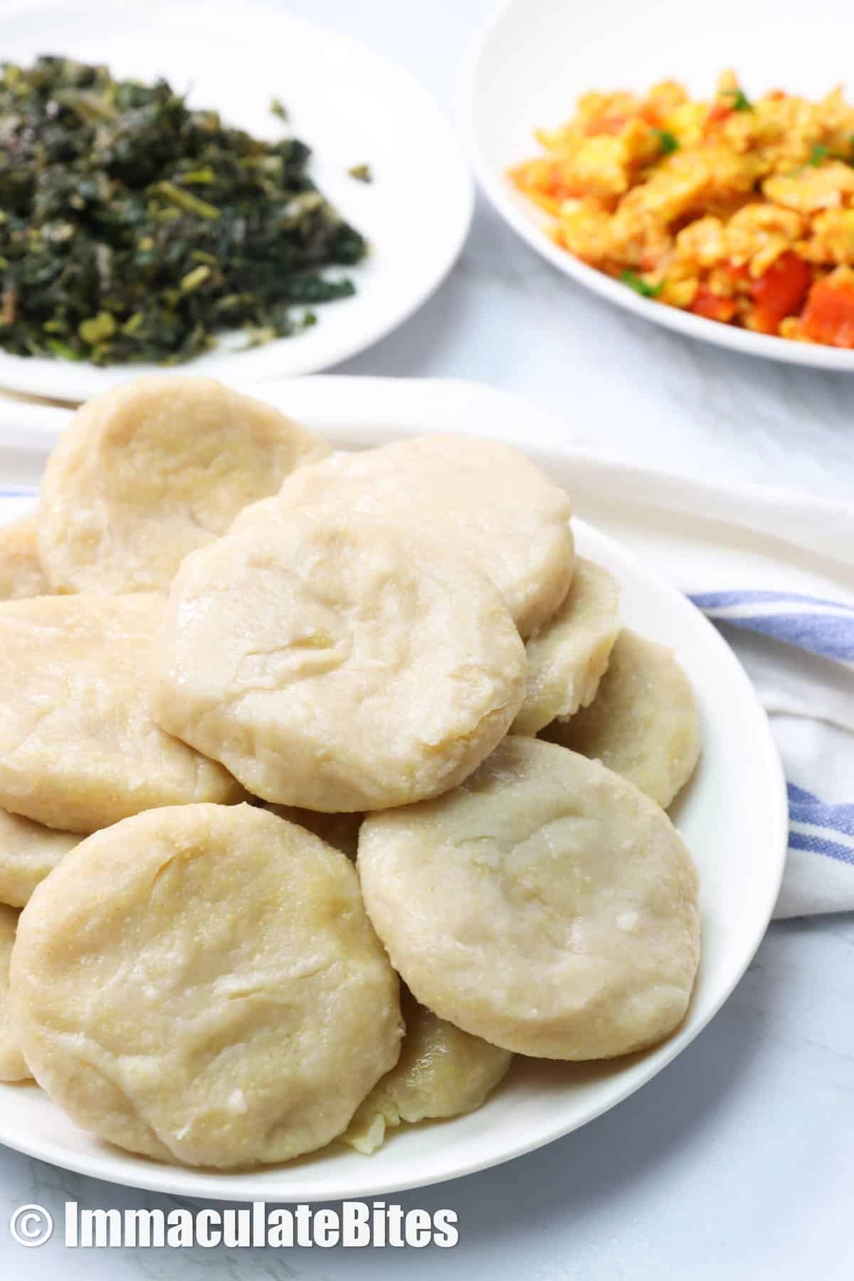 A plateful of Caribbiean boiled dumplings with side dishes