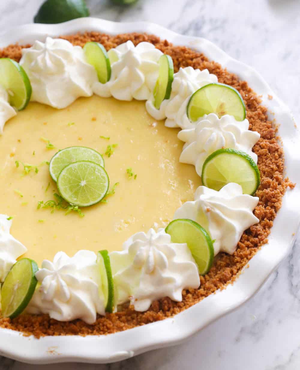 Whole Key Lime Pie with whipped cream and lime slices