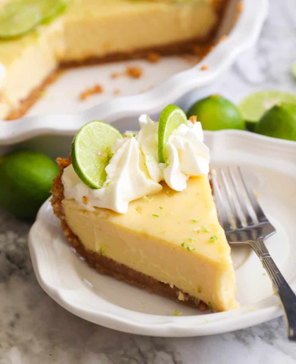A slice of key lime pie on a white plate