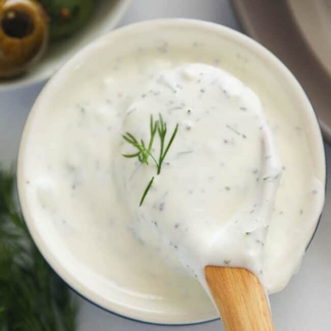 A bowl of homemade dill sauce with olives