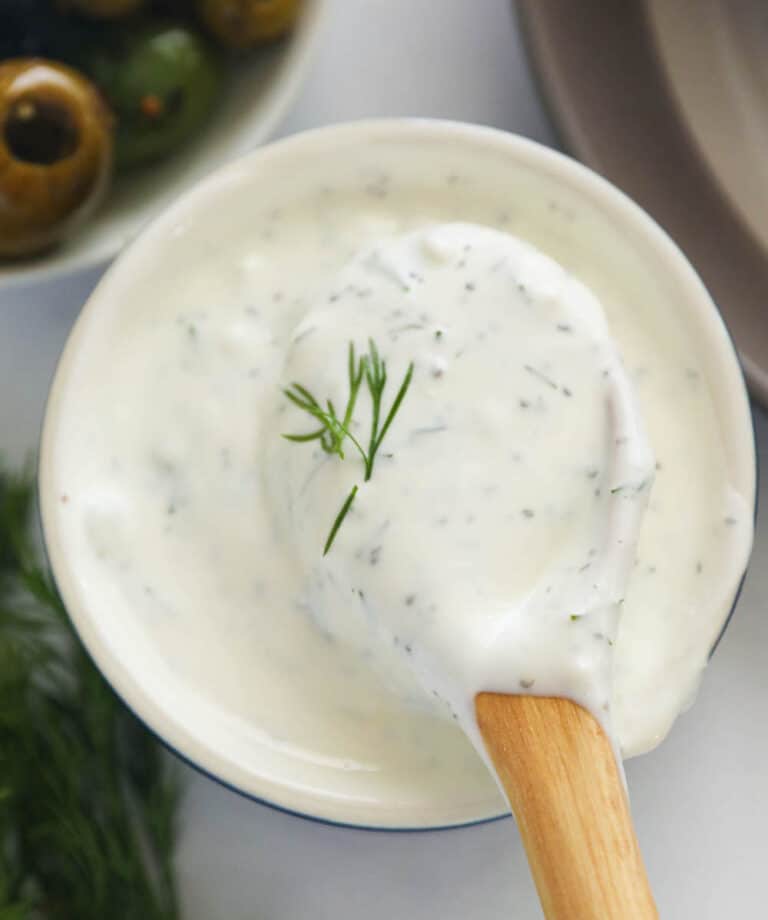 A bowl of homemade dill sauce with olives