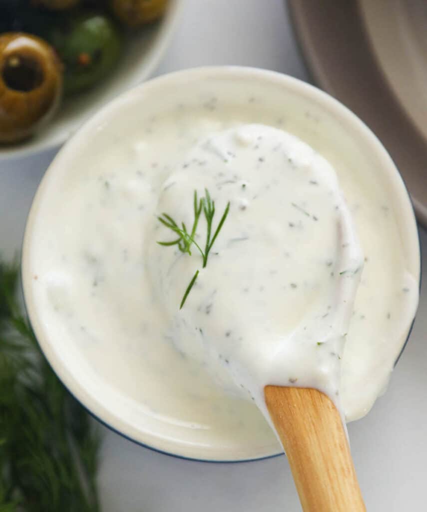 A bowl of homemade dill sauce with olives