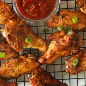 Grilled chicken wings with red sauce on the side