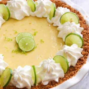 Whole Key Lime Pie with whipped cream and lime slices