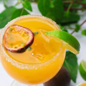 Passion fruit margarita garnished with mint and passion fruit