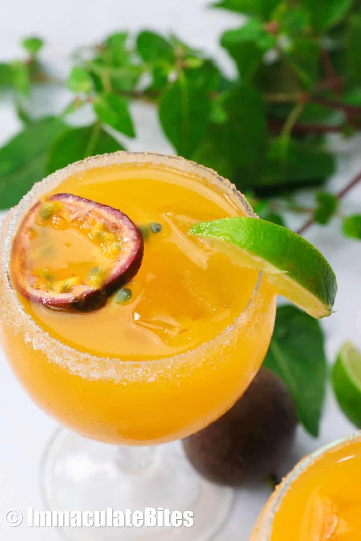 Passion fruit margarita garnished with mint and passion fruit