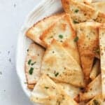 A white plate with fresh pita chips