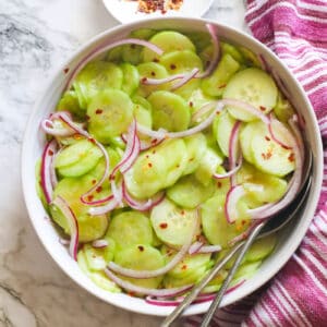 Cucumber and onion salad in a white bowl