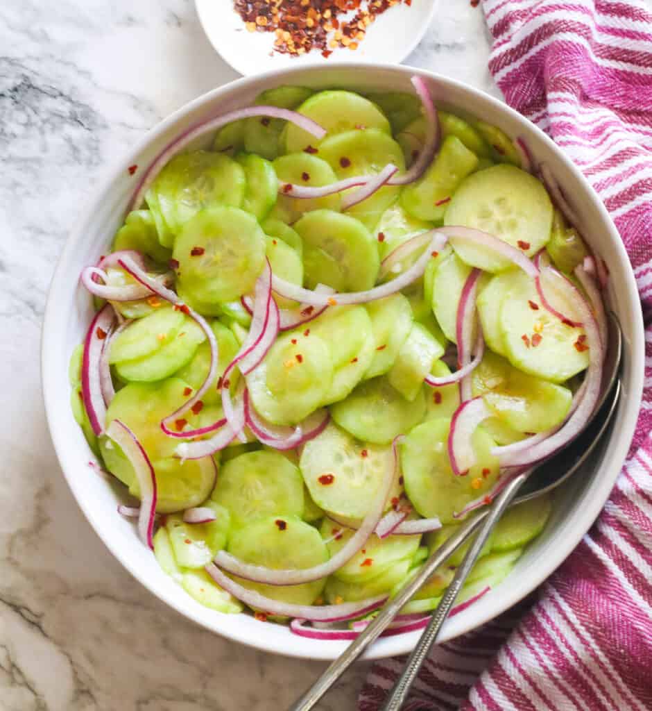 Cucumber and onion salad in a white bowl