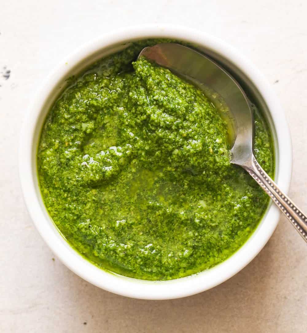 Fresh basil pesto in a white bowl