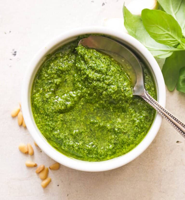 Pesto in a white bowl with a spoon