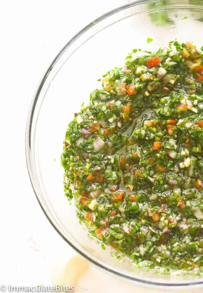 Fresh chimichurri in a clear glass bowl