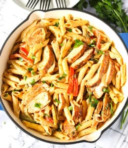 A skillet full of jerk chicken pasta