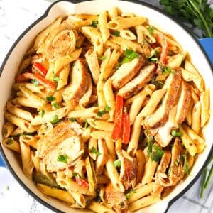 A skillet full of jerk chicken pasta