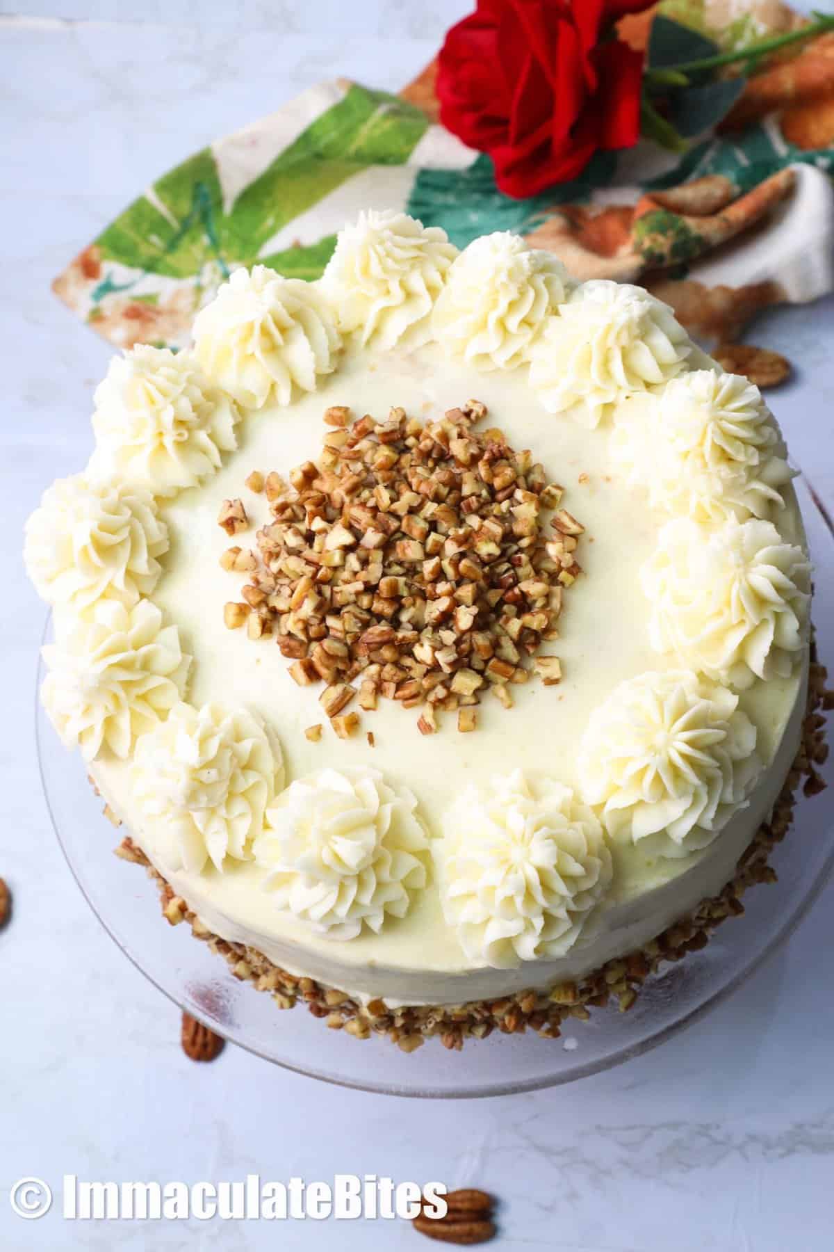 Italian cream cake topped with pecan nut view from above