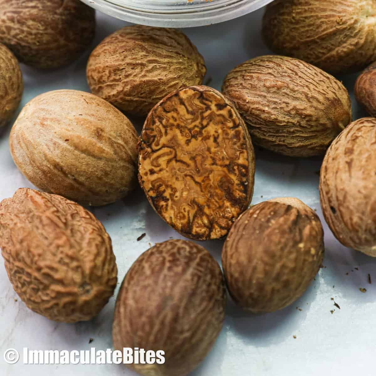 A closeup of whole and grated nutmeg for an inside view